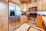 Fully equipped kitchen with cookware, flatware, and utensils